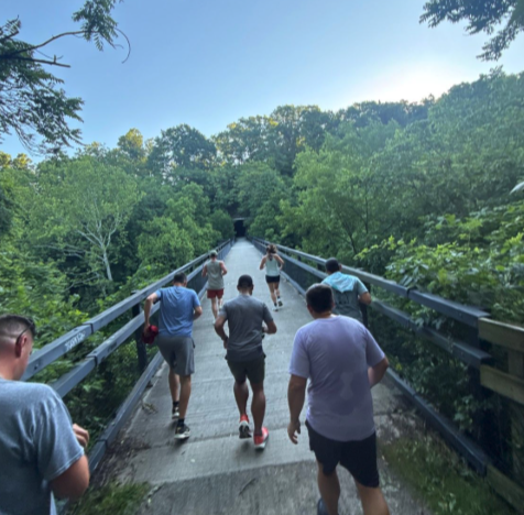 The crew running over the bridge on the Montour Trail